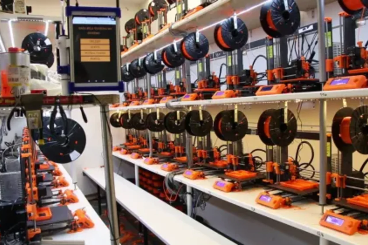 Rows of desktop 3D printers in a workshop, ready for small-scale fabrication and local hardware production.